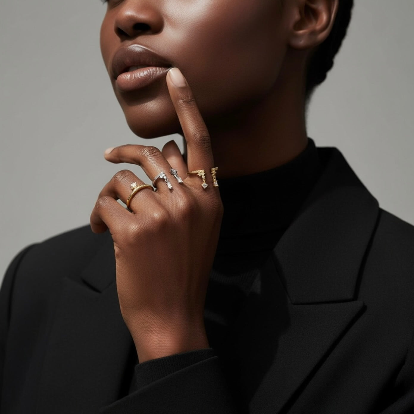 Close-up of a model’s hand near her face wearing the adjustable zircon drop ring in 925 sterling silver, with sparkling zircon drops catching the light against a dark background.