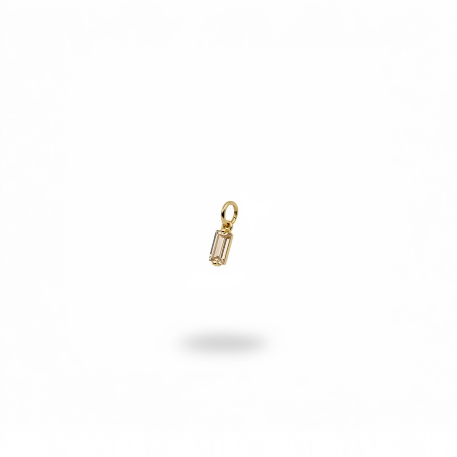 champagne-colored baguette crystal charm with gold-plated frame.