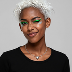 Close-up of silver-plated heart pendant necklace on model