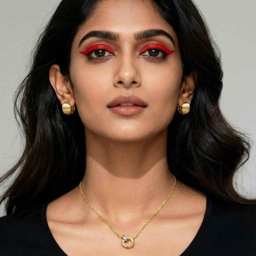 Woman wearing square ribbed gold huggie earrings
