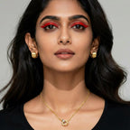 Woman wearing square ribbed gold huggie earrings