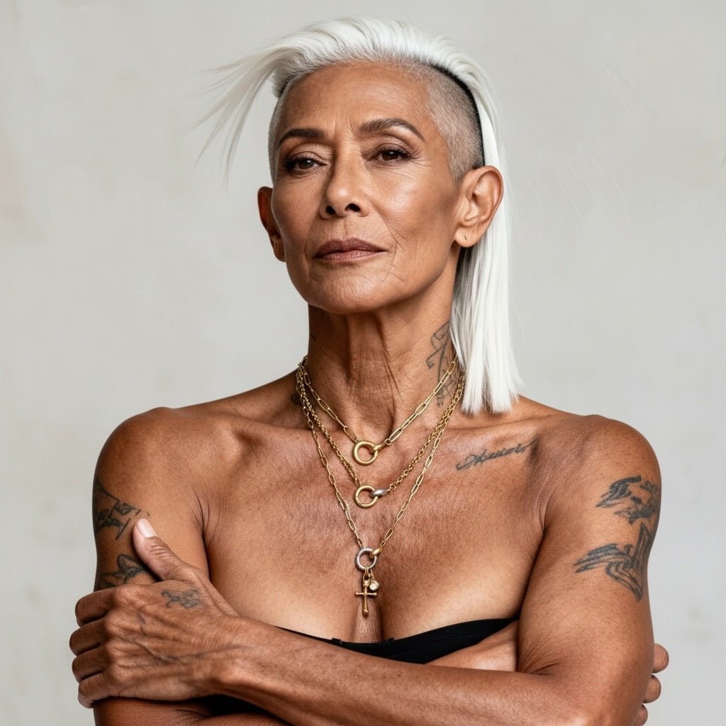Charm Link Necklace worn by a model with tattoos and silver hair, showcasing its elegance and layered design.