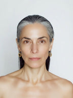 Geometric Link Earrings worn on model ear close-up