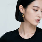 Geometric Link Earrings worn on model side view