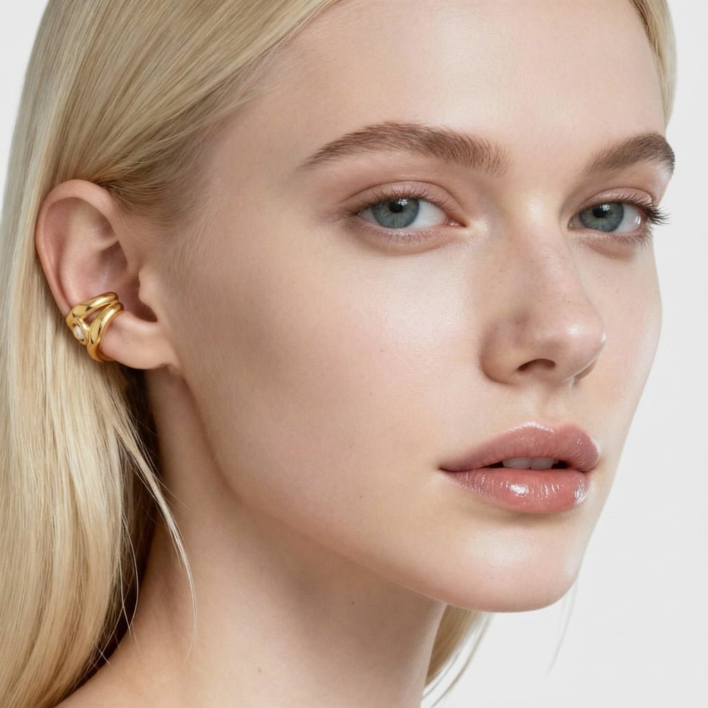 Blonde model wearing gold pearl ear cuff with 18K gold plated clip-on design