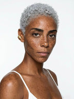 Model with short hair wearing sculptural gold pearl ear cuff – no piercing clip-on