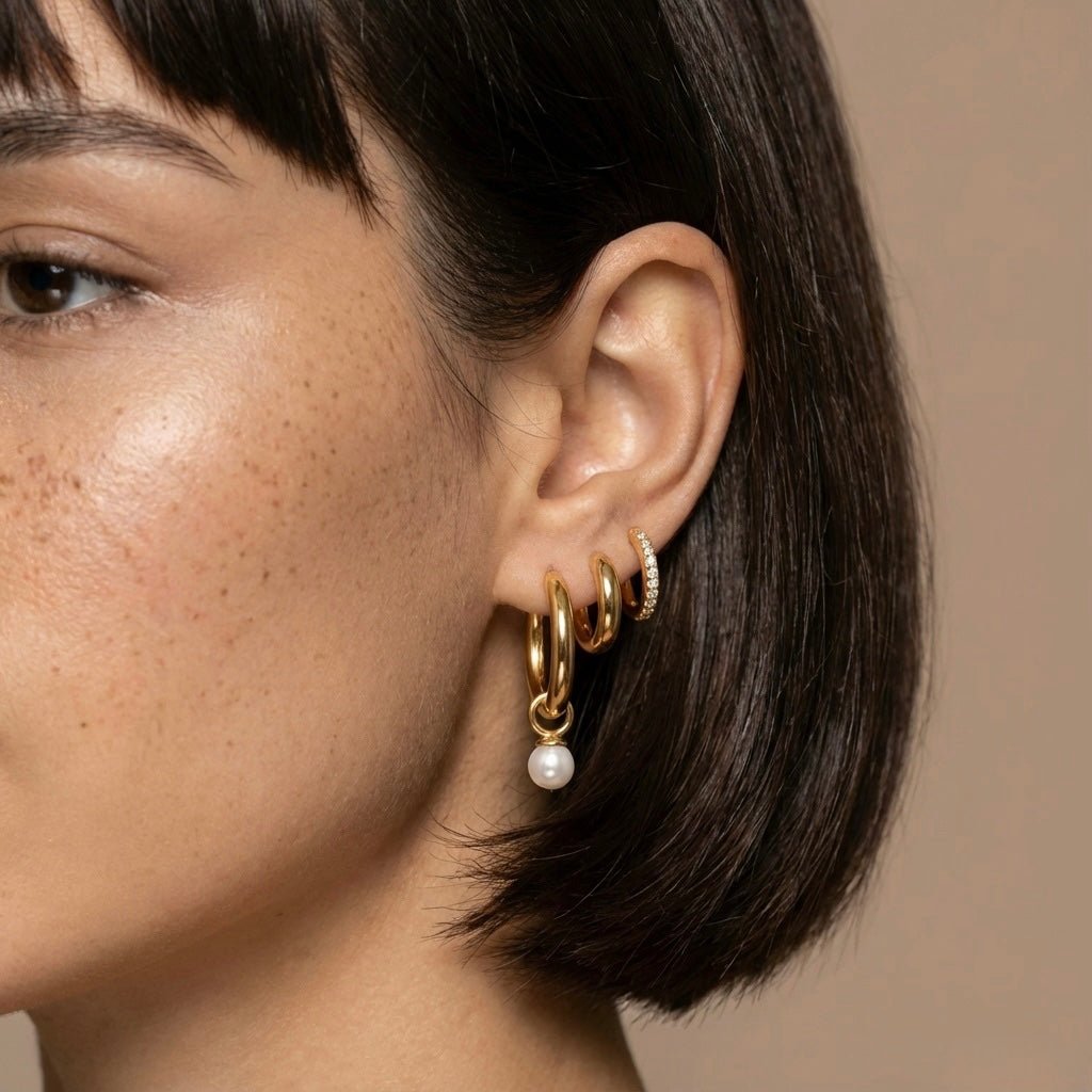 Model wearing gold-tone zircon and pearl hoop earrings – right-side view