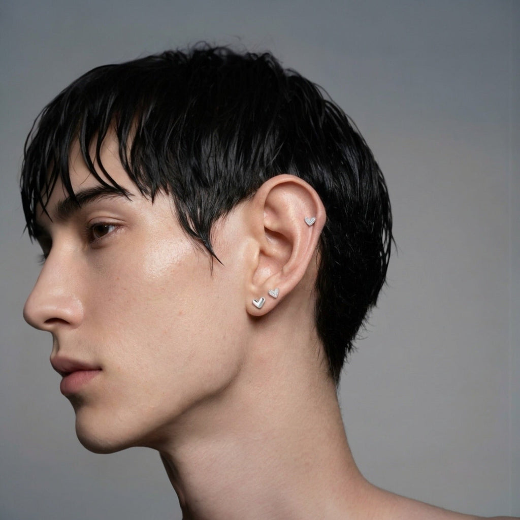 Heart stud earrings worn on model ear minimalist studs