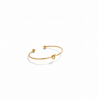 Gold knot cuff bracelet in 18K gold-plated stainless steel on a white background
