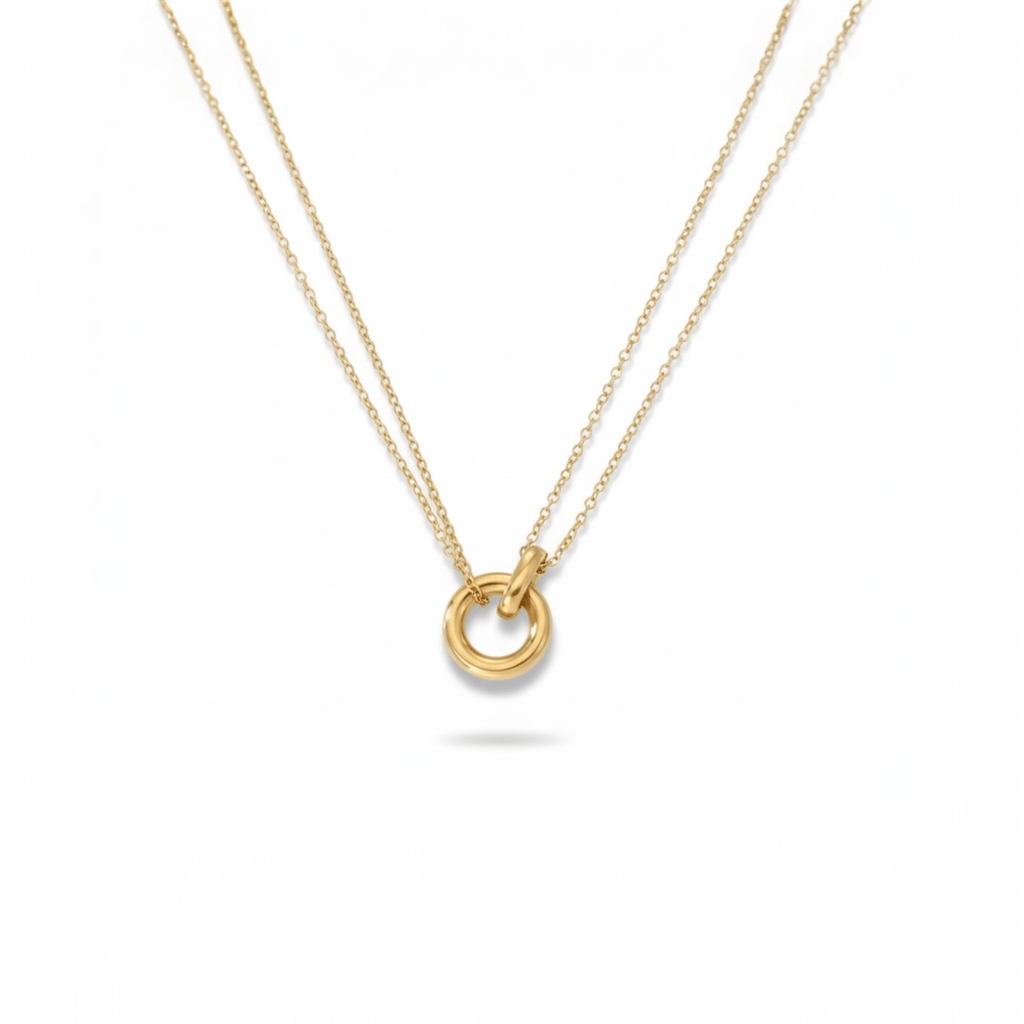 Layered Circle Necklace layered chains flat lay on white background