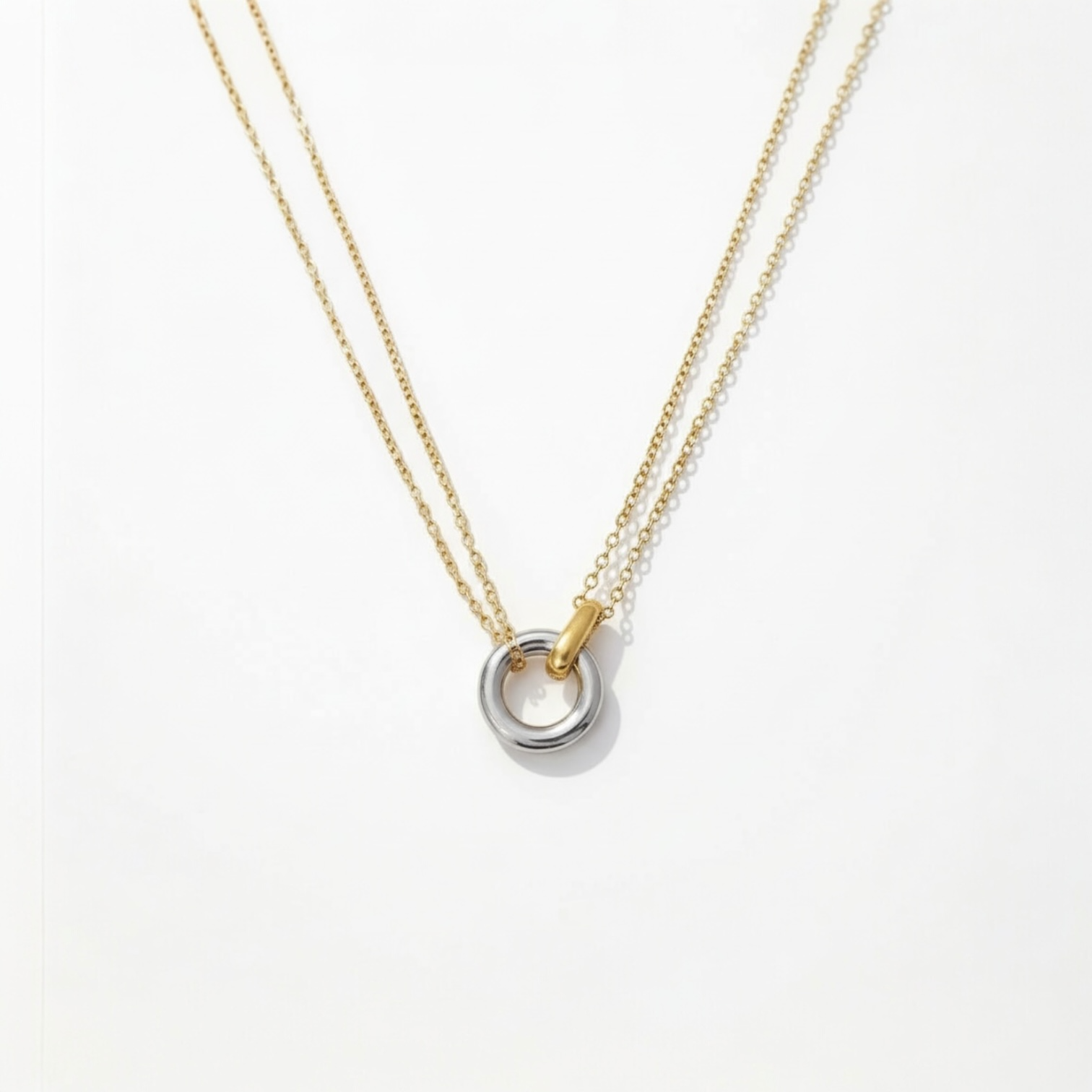 Layered circle pendant necklace shown in both 18K gold-plated and silver-plated finishes