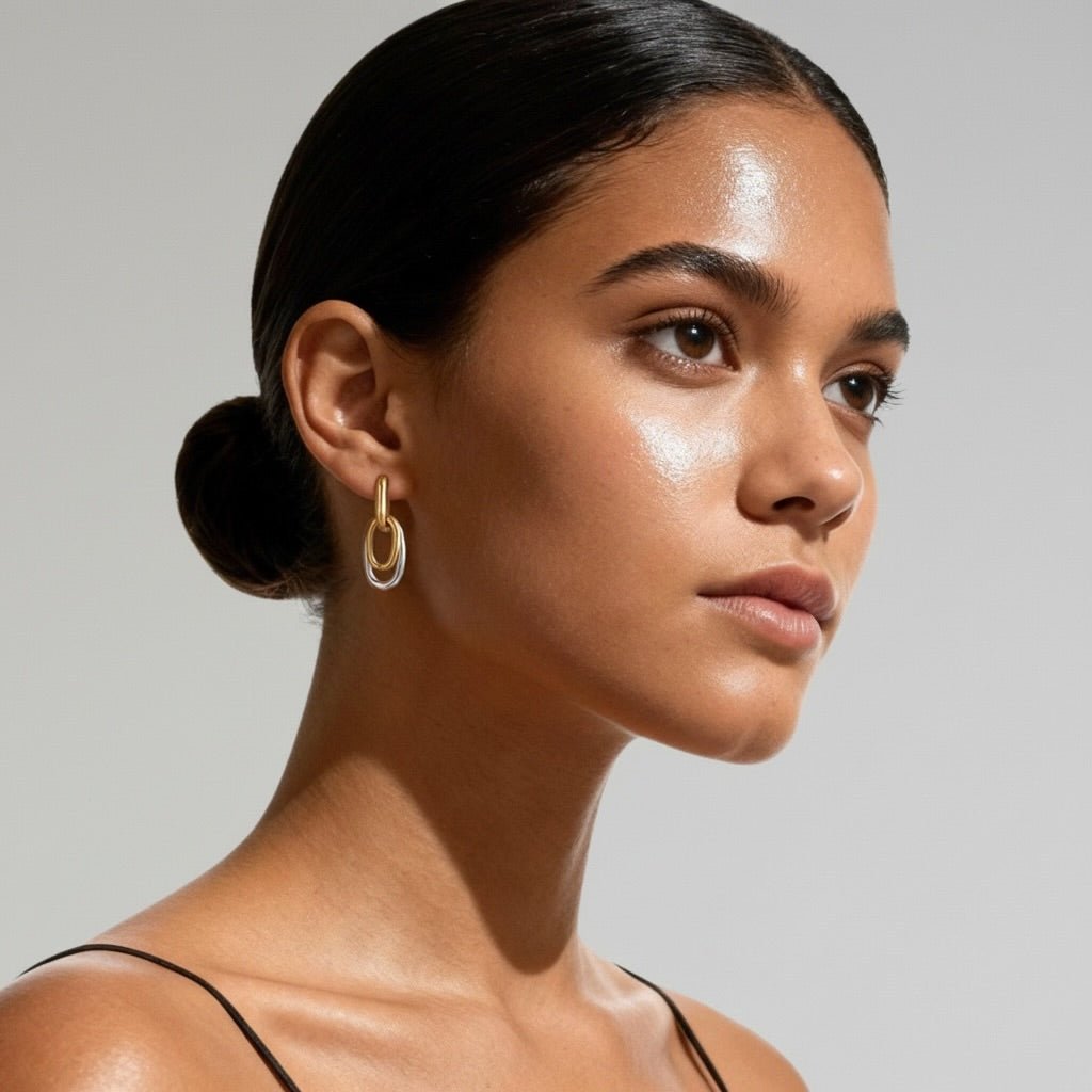 Model wearing Oval Link Hoops 18K gold-plated earrings with an elegant, minimalist design.