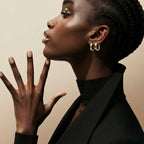 Model wearing two-tone gold and silver plated huggie hoop earrings – front view